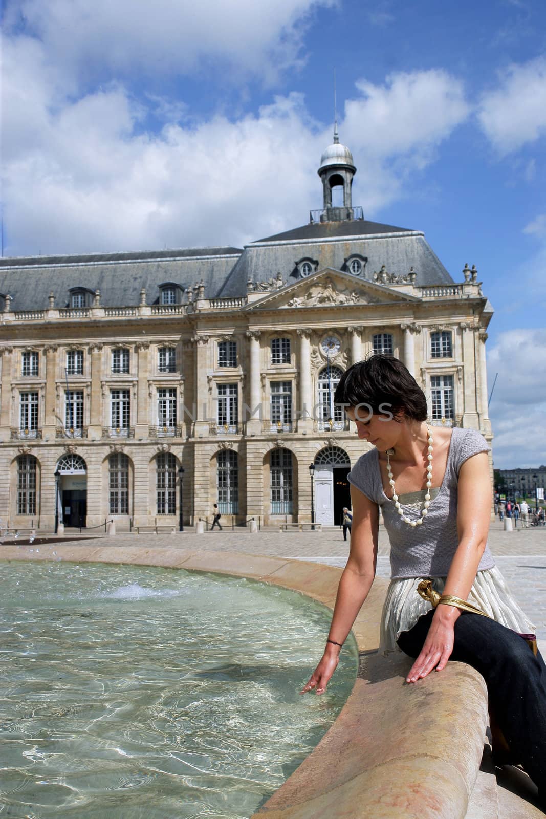 Woman sat by fountain