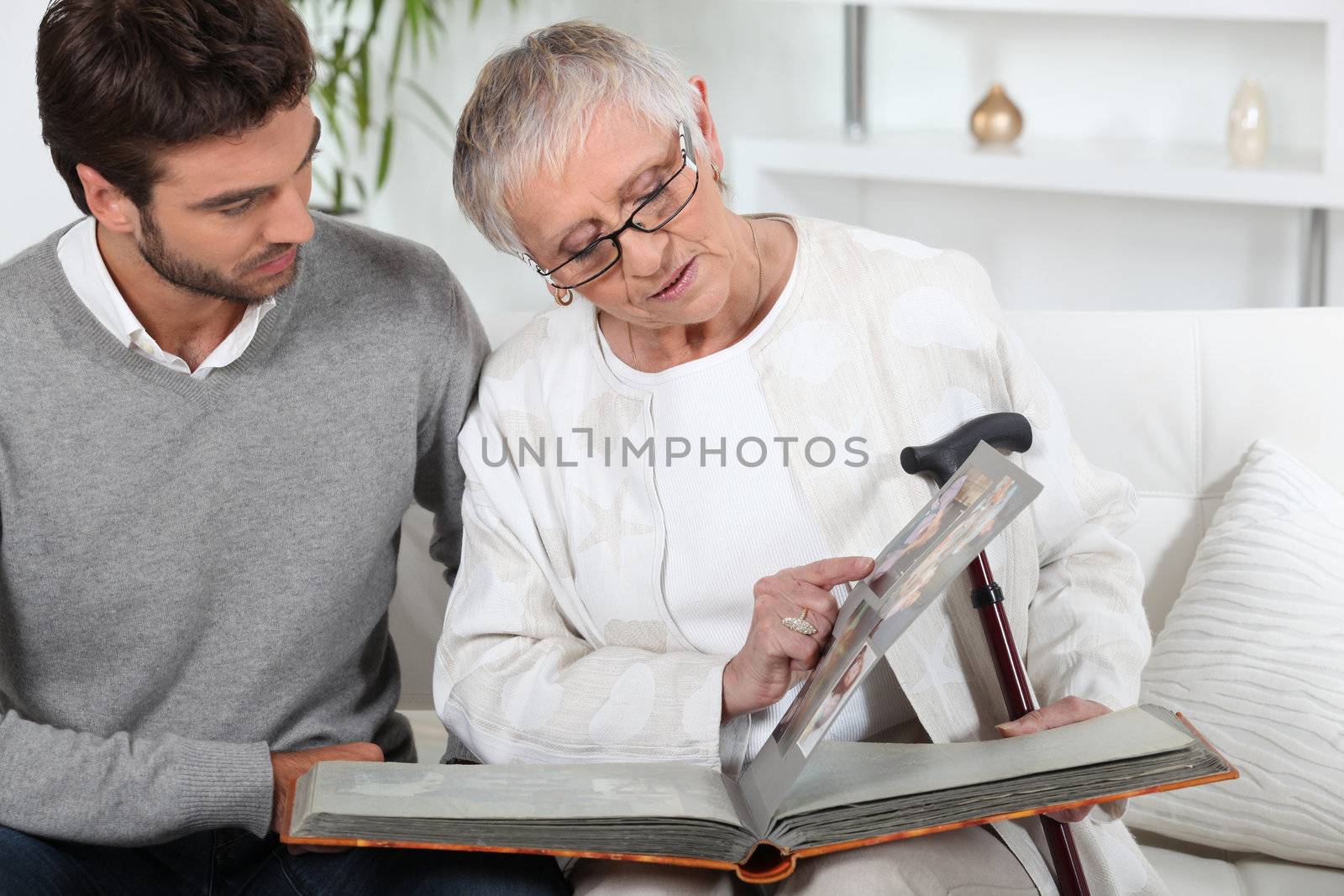 Elderly person looking at photos with son