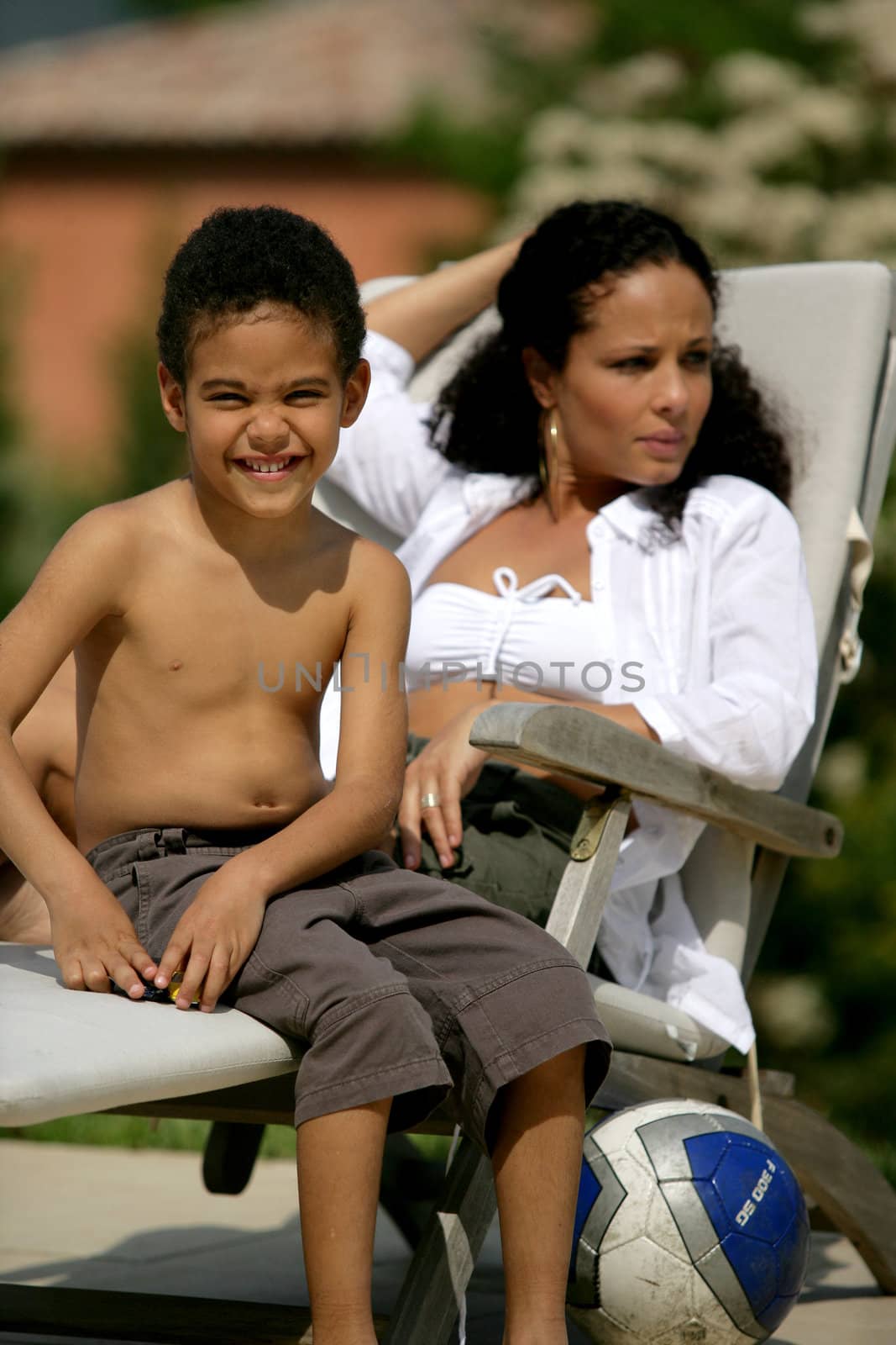 Woman and smiling boy on a deckchair