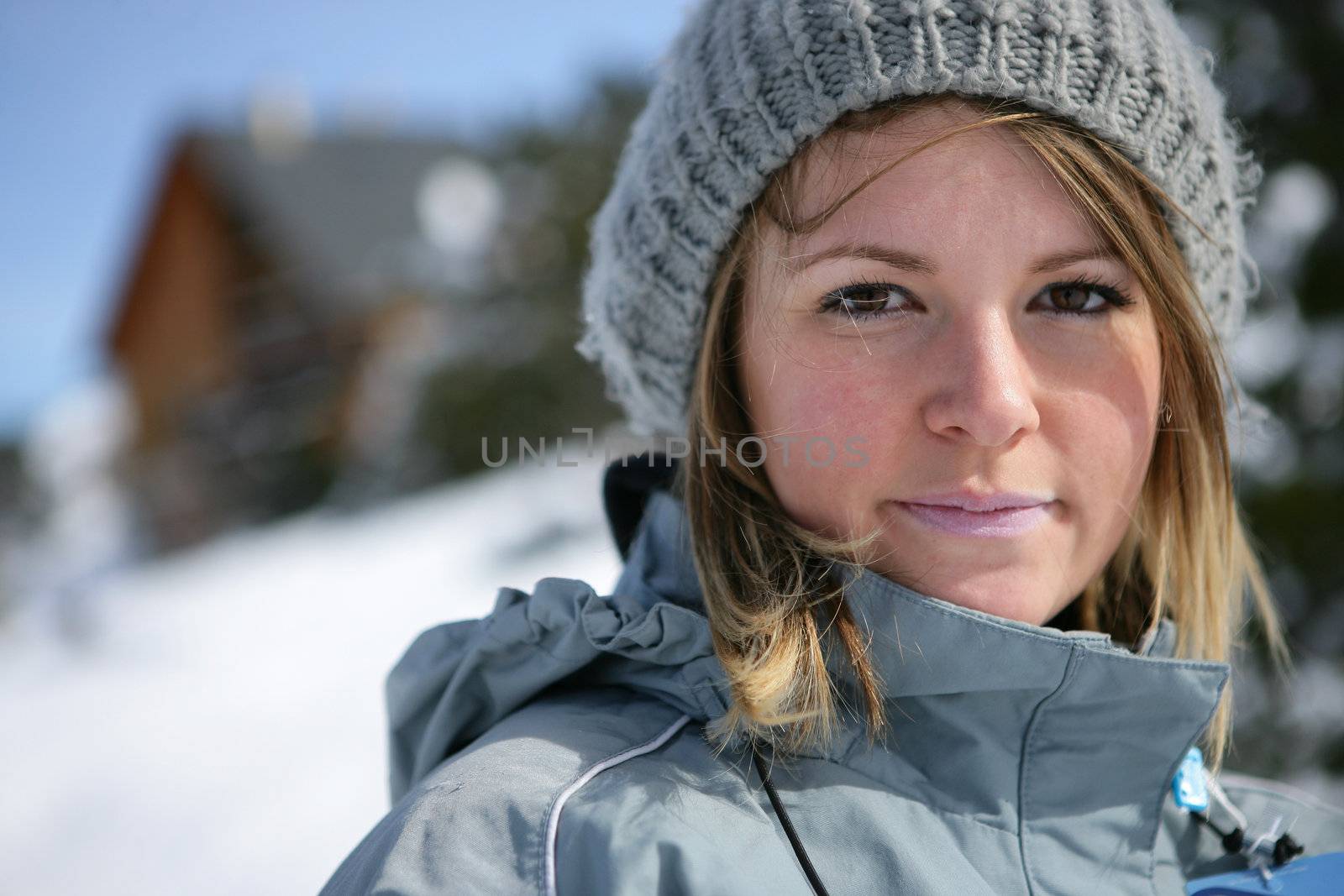 Blond woman stood on snowy mountain