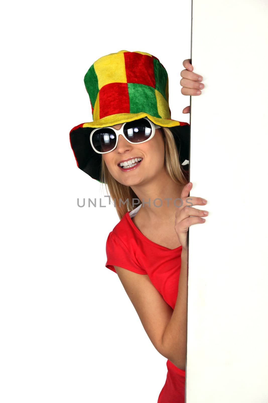 Woman wearing a comical hat and sunglasses