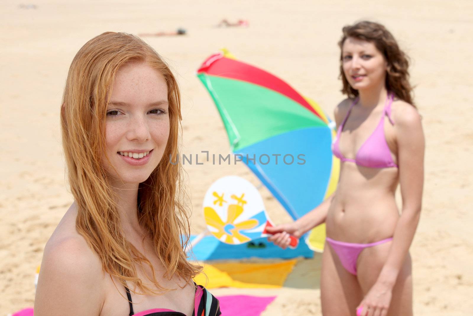 portrait of two girls playing rackets on the beach