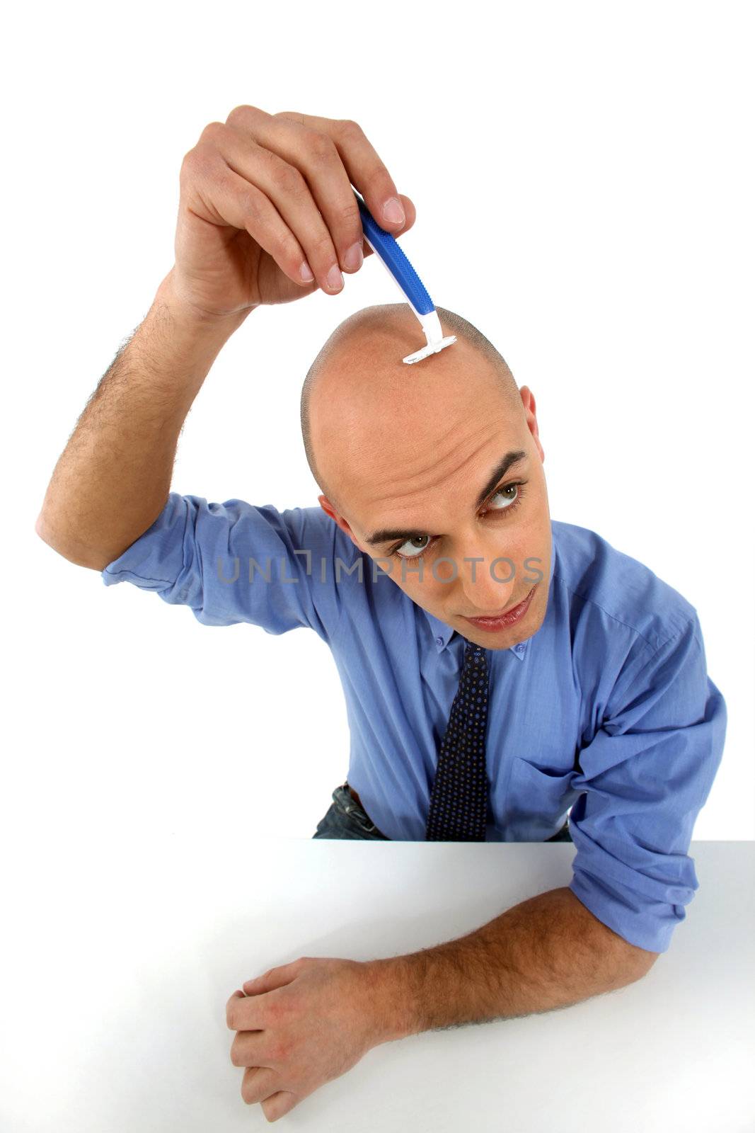 man shaving his head