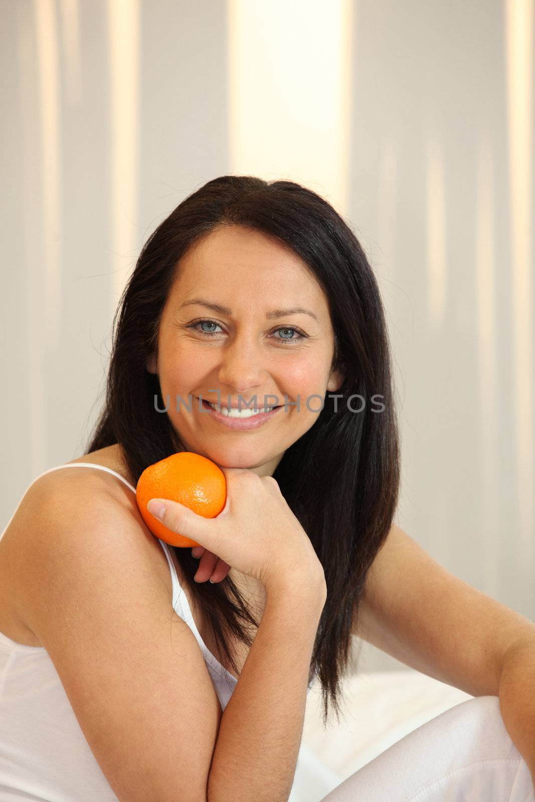 Woman holding an orange