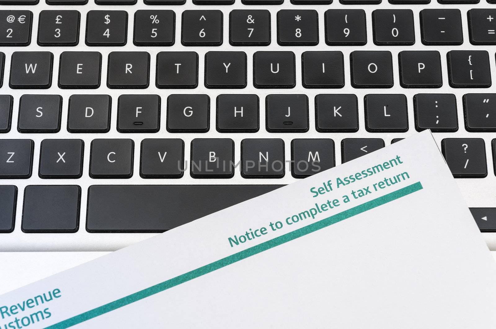 Detail of blank tax return form on top of computer keyboard.