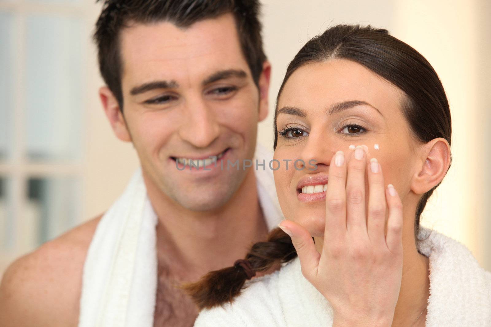 Woman applying under eye cream