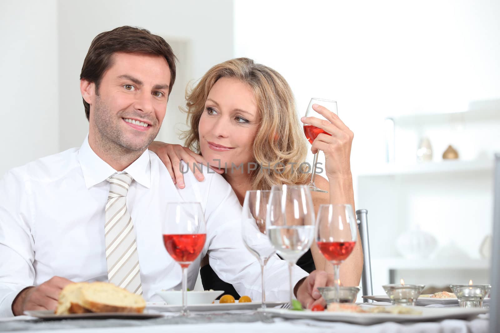 Couple sat at table with wine