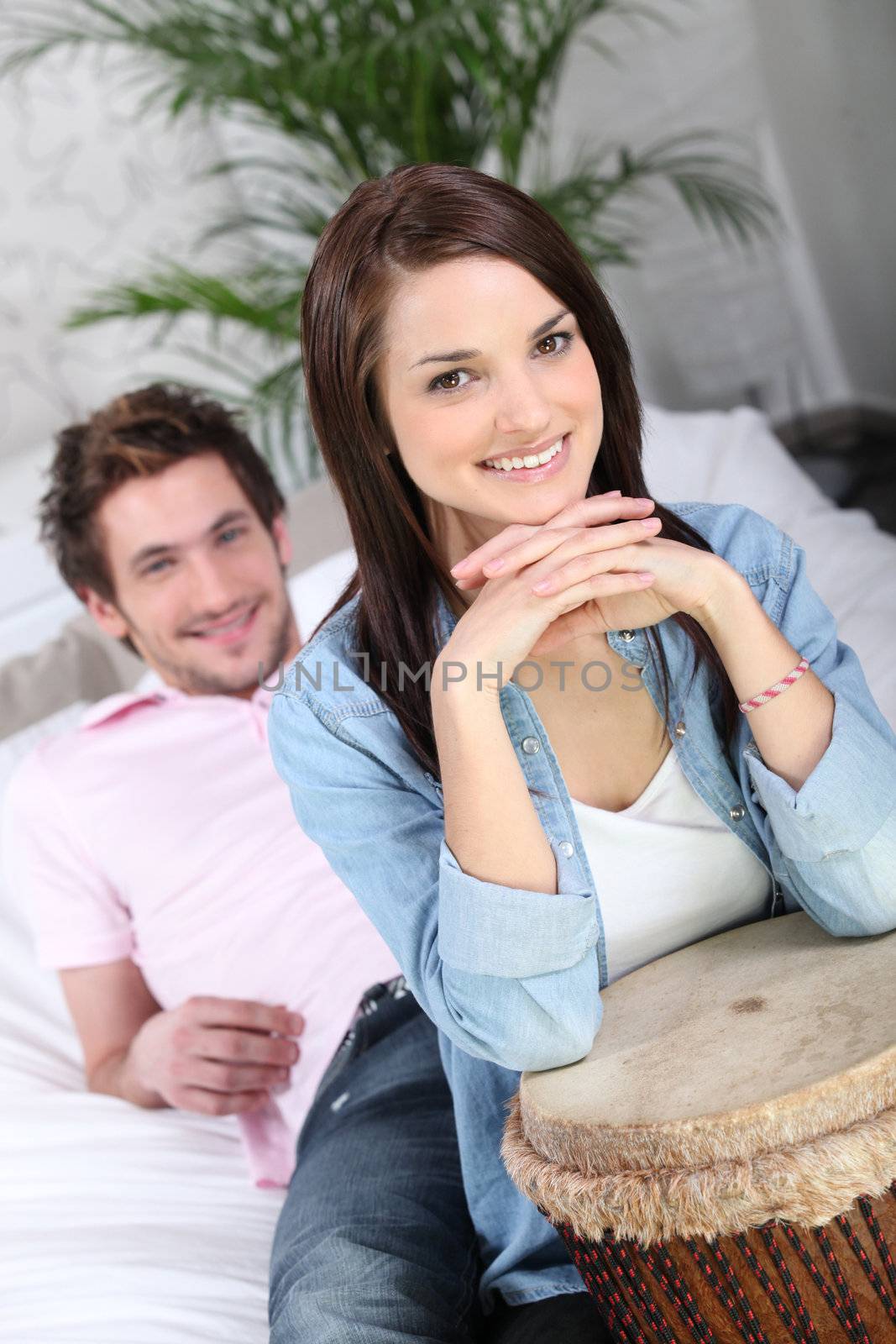 Young couple playing the tam-tam