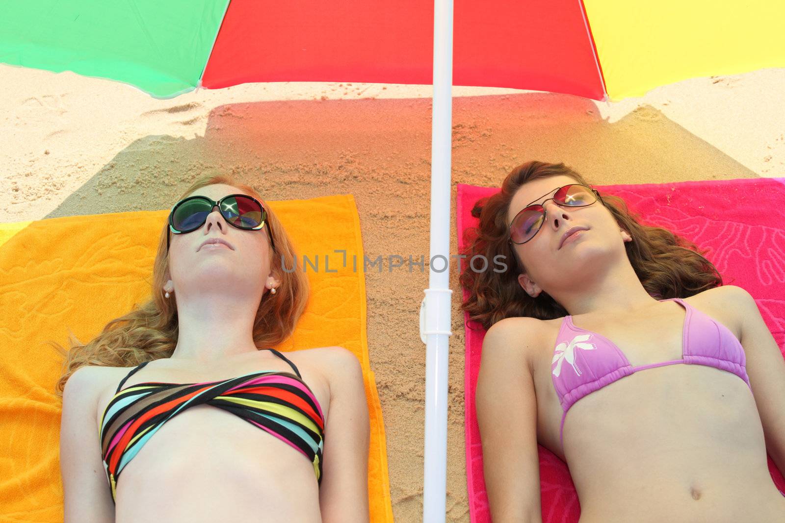 Teenage girls lying on the beach