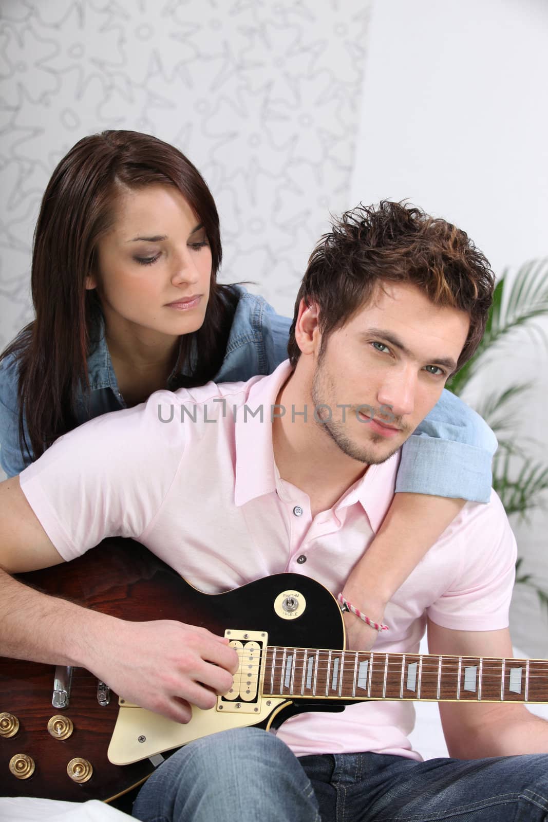 Young woman and young man with guitar