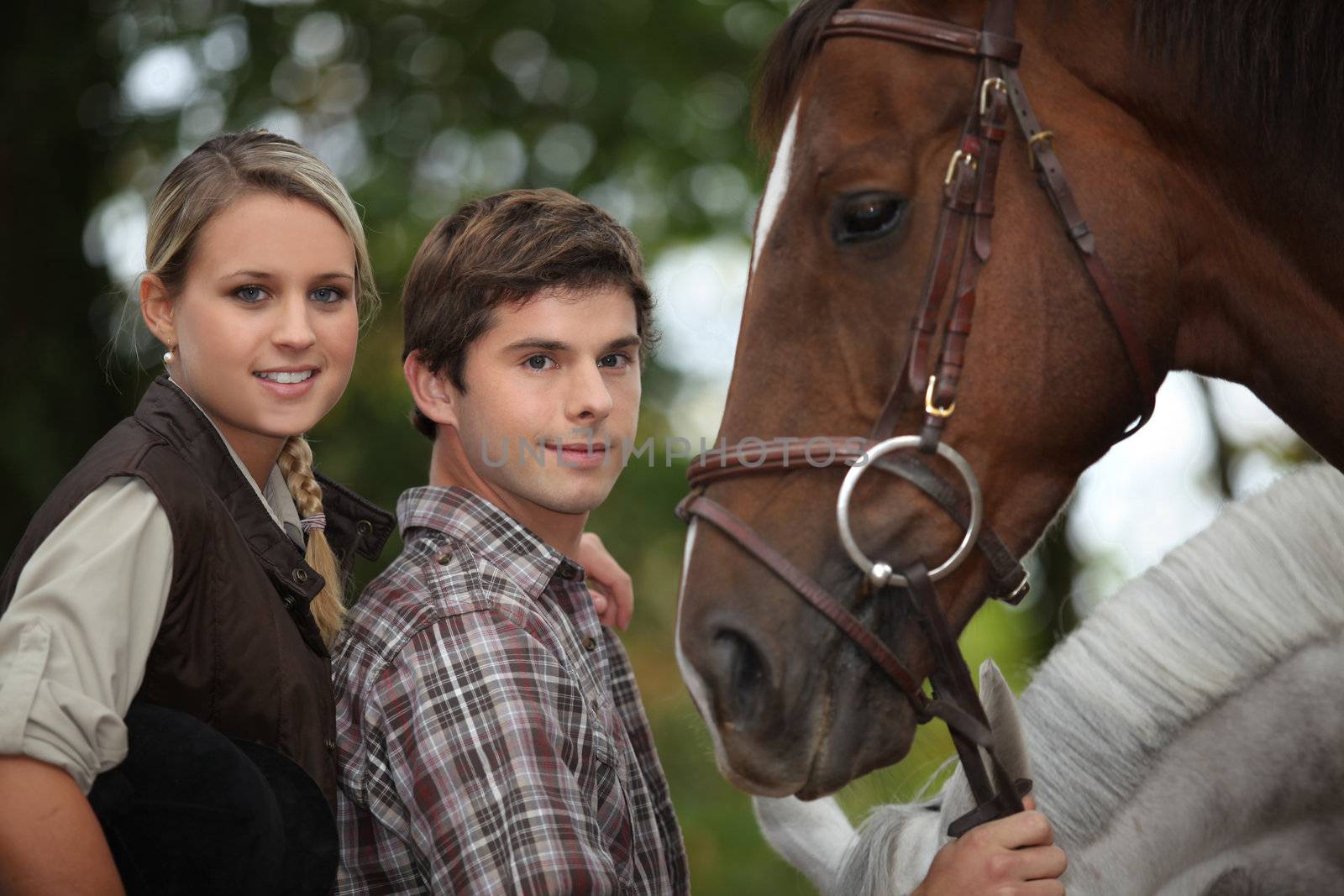 two young people and a horse