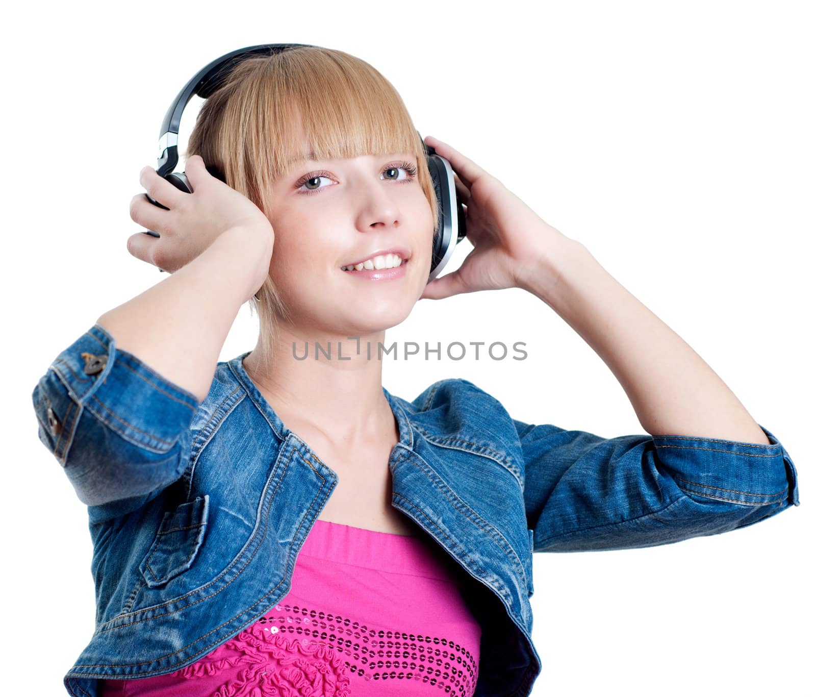 Young attractive woman listing to music with headphones against white background