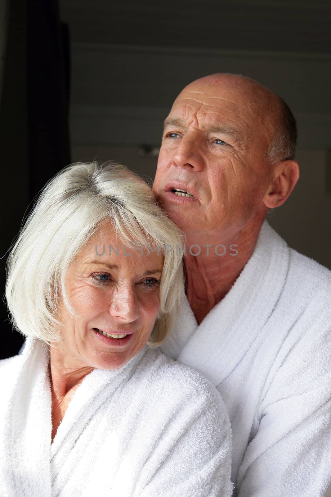 Elderly man hugging his wife