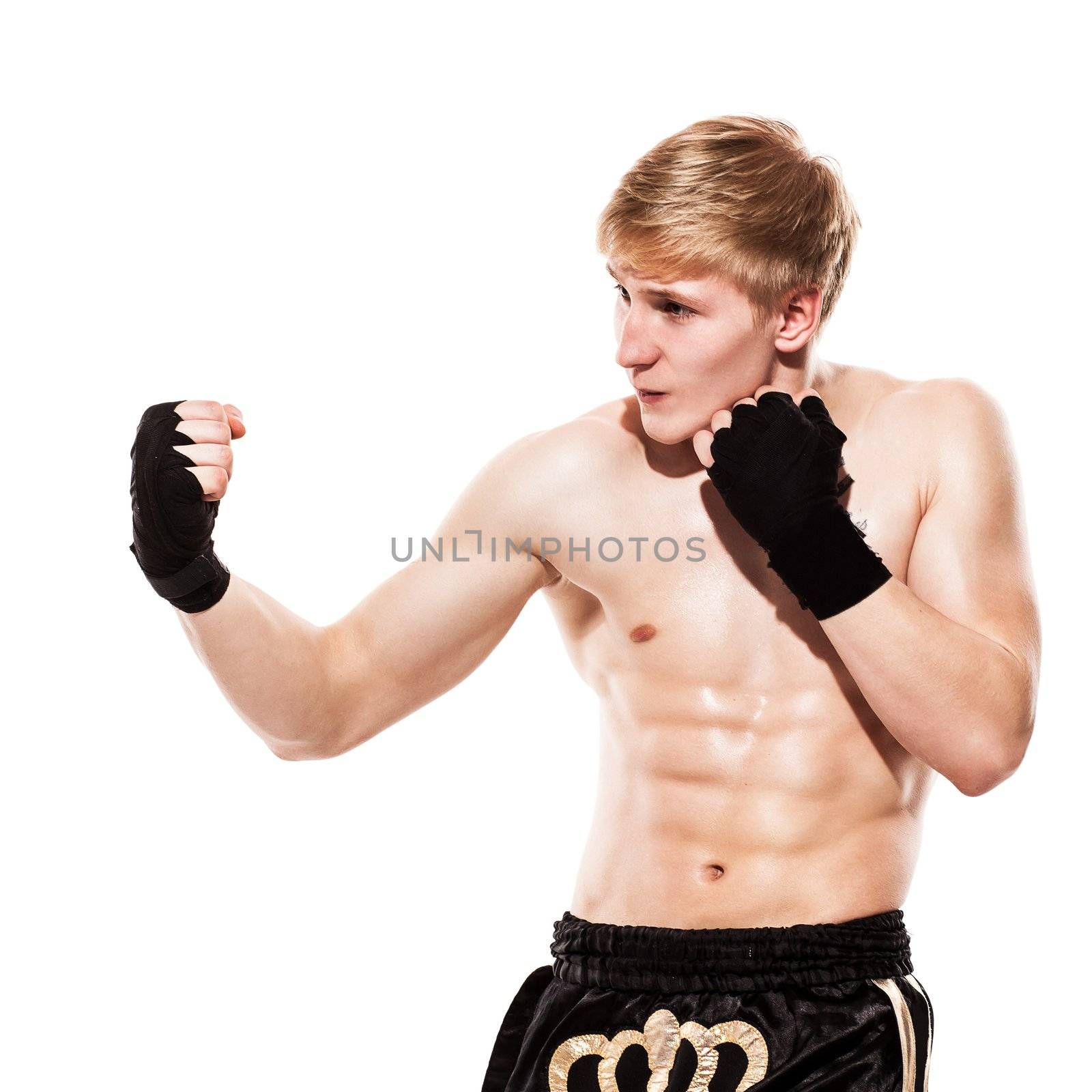 Young handsome fighter in shorts isolated over white baqckground