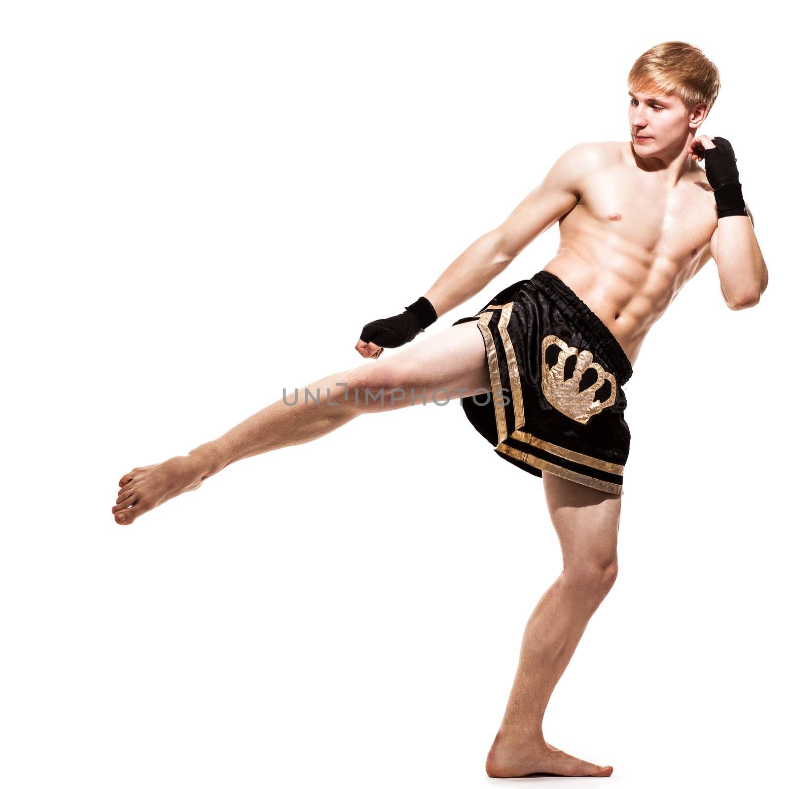 Young handsome fighter in shorts isolated over white baqckground