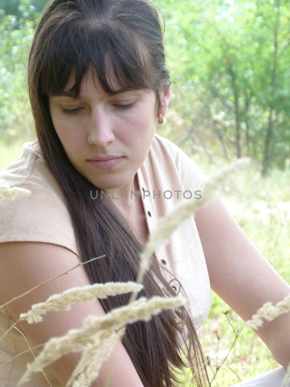 Young brunette girl walks in the park