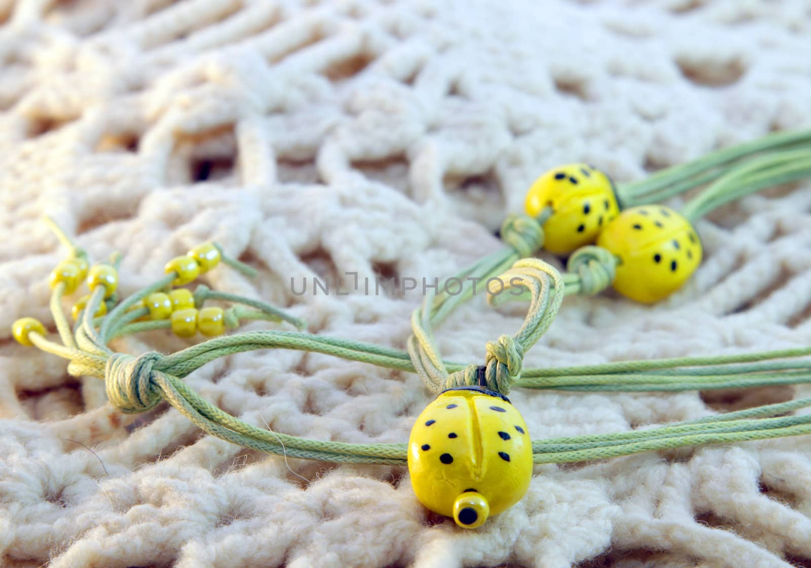 clay handmade yellow ladybirds on a knitted background