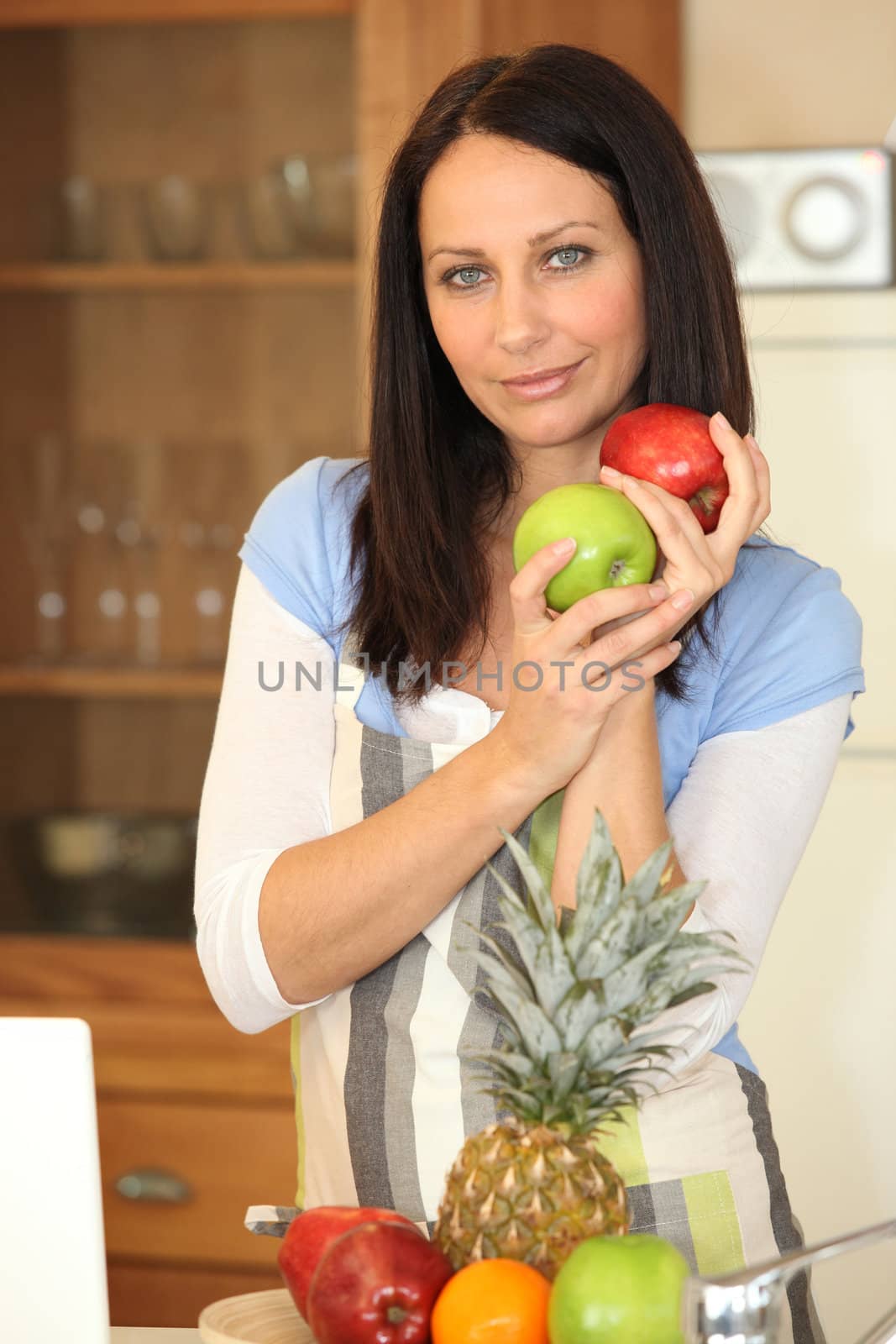 Woman with fruit in a kitchen