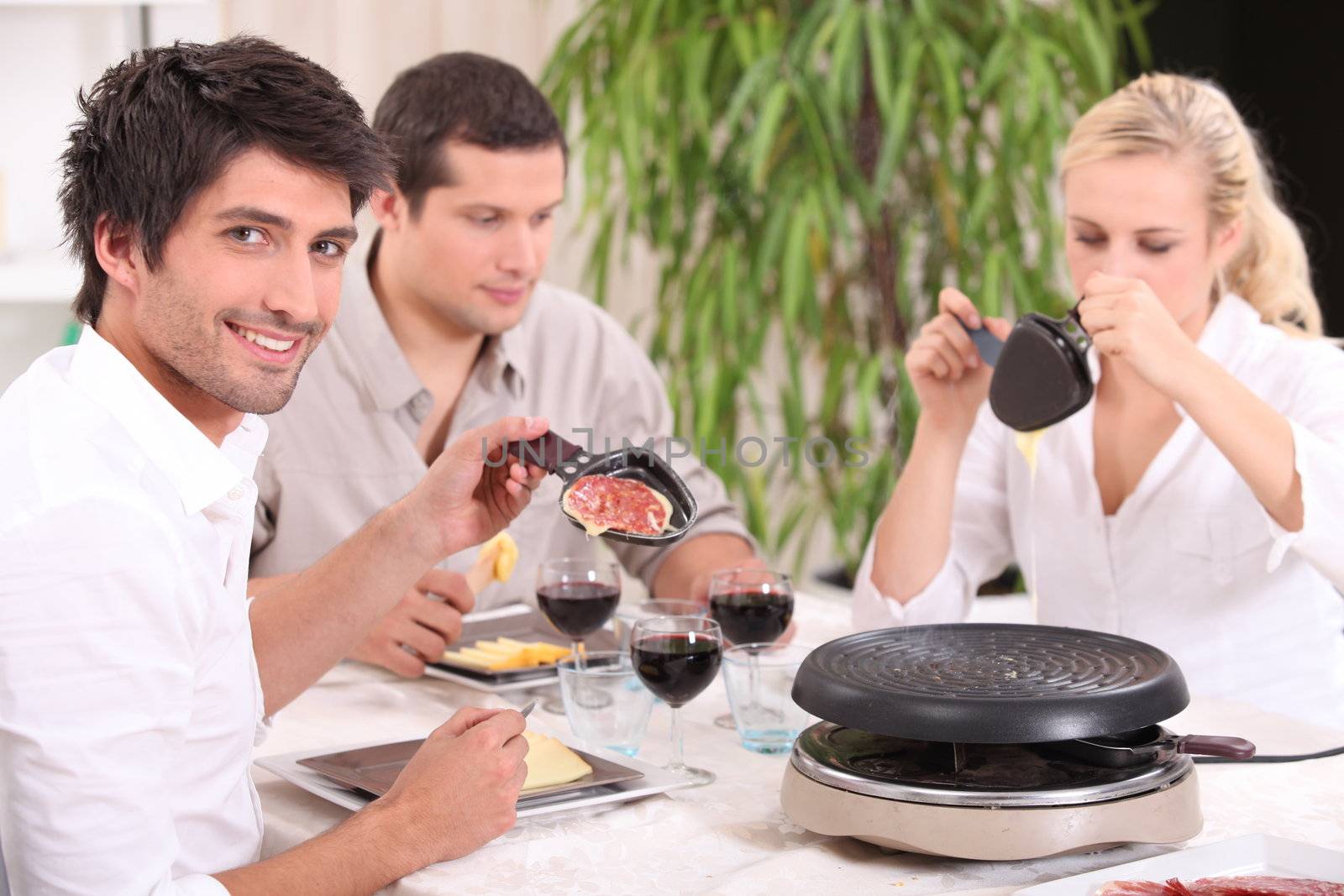 Friends eating raclette