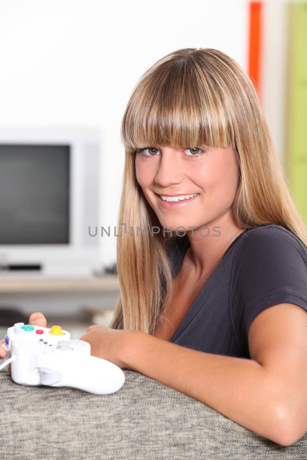Blond teenage girl with video game controller