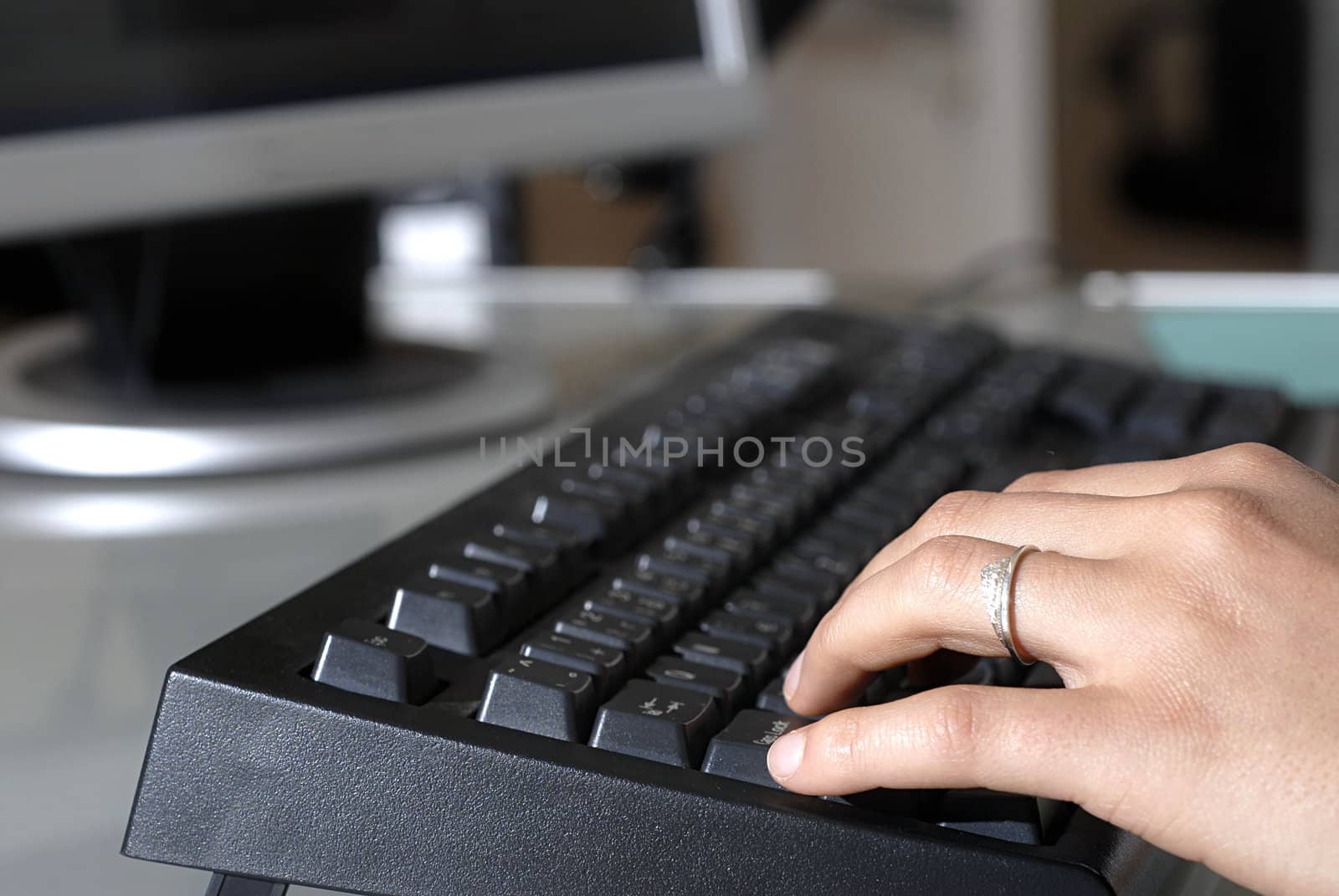 A female typing on a keyboard.