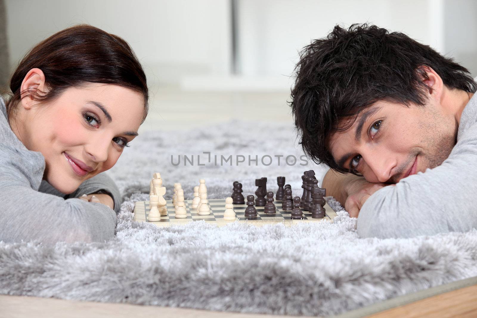 Couple playing chess in bed