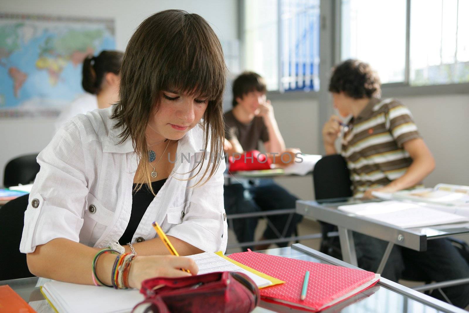 a teenage girl studying in a classroom by phovoir