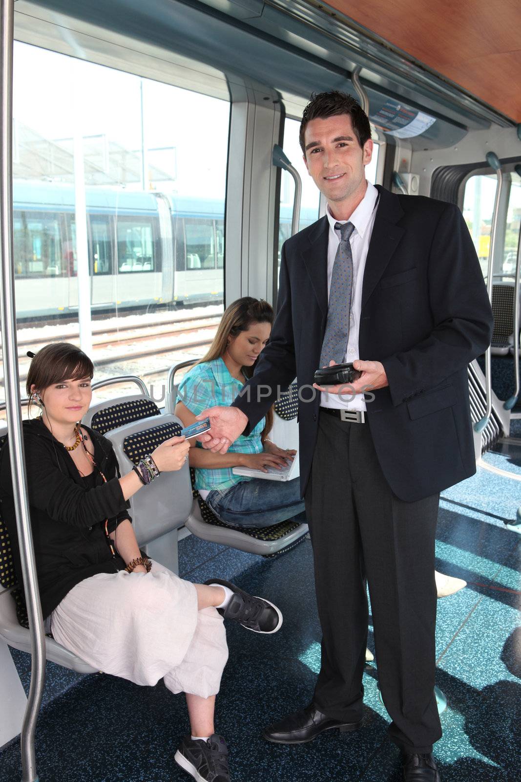 Man checking tram tickets by phovoir