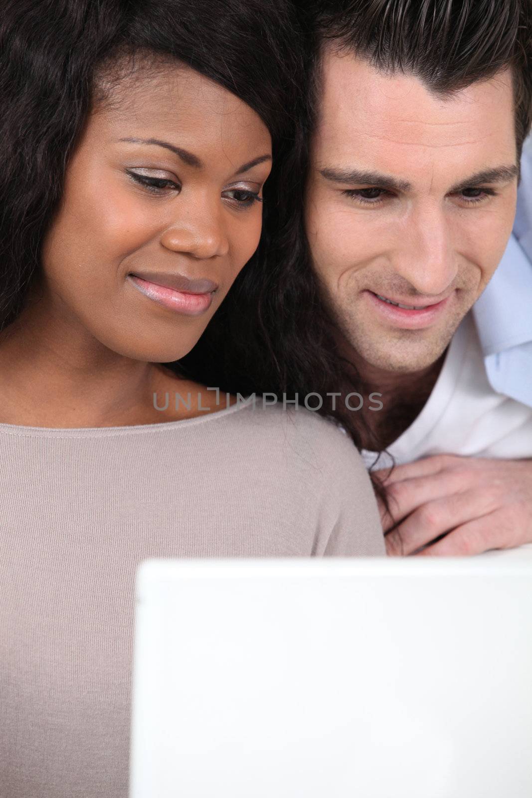 Couple watching laptop by phovoir