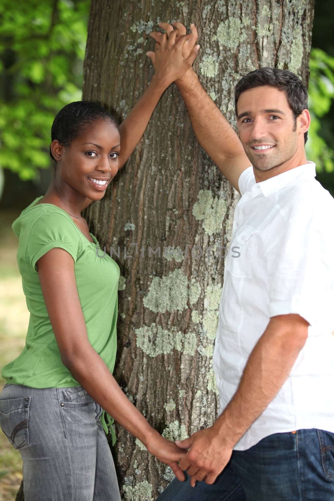 Couple touching tree