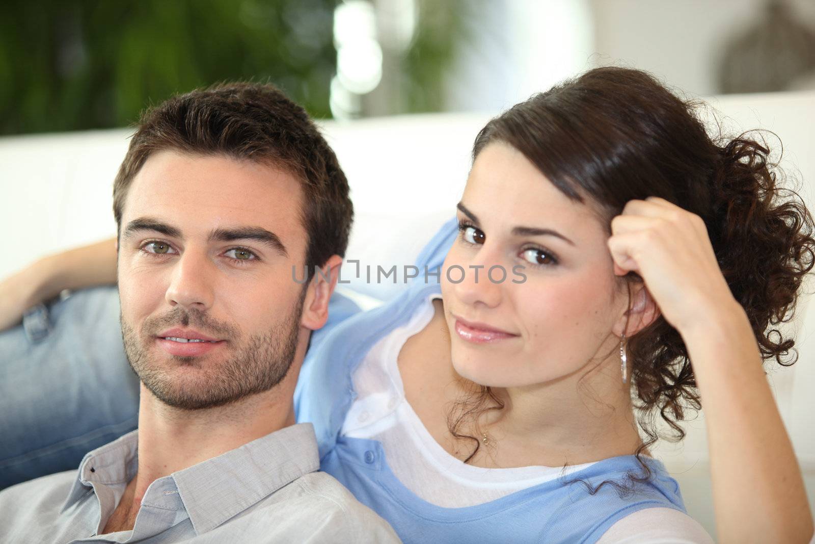 Lazy couple laying on sofa