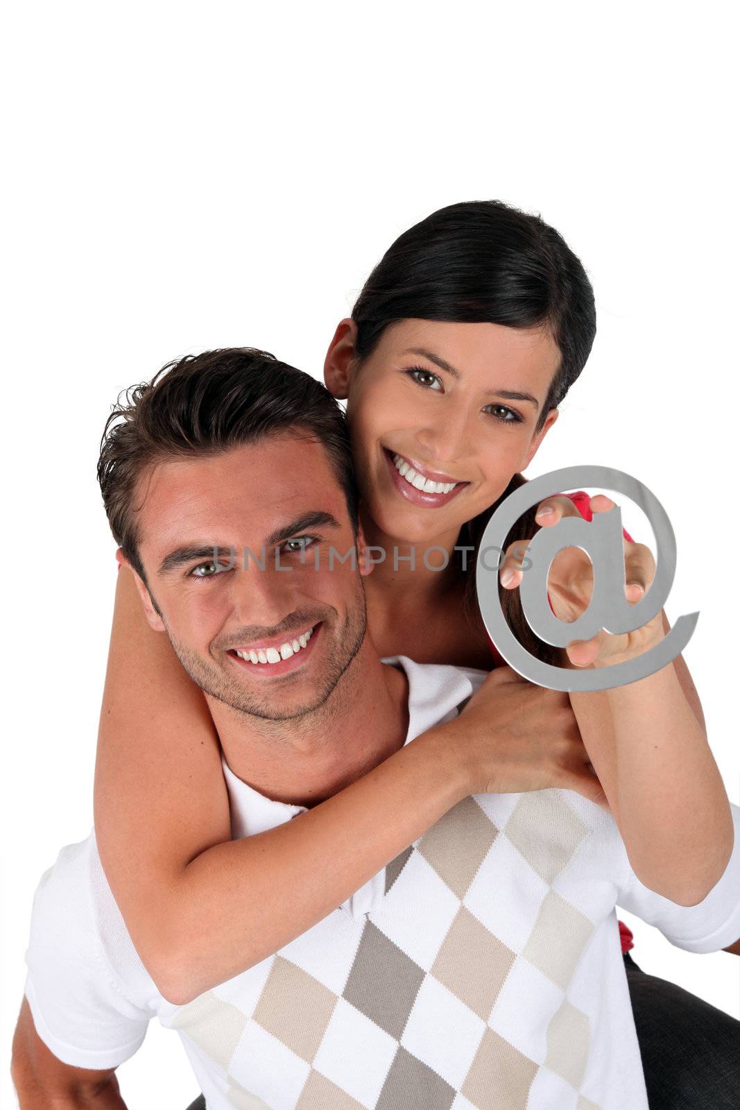 Couple holding an at symbol