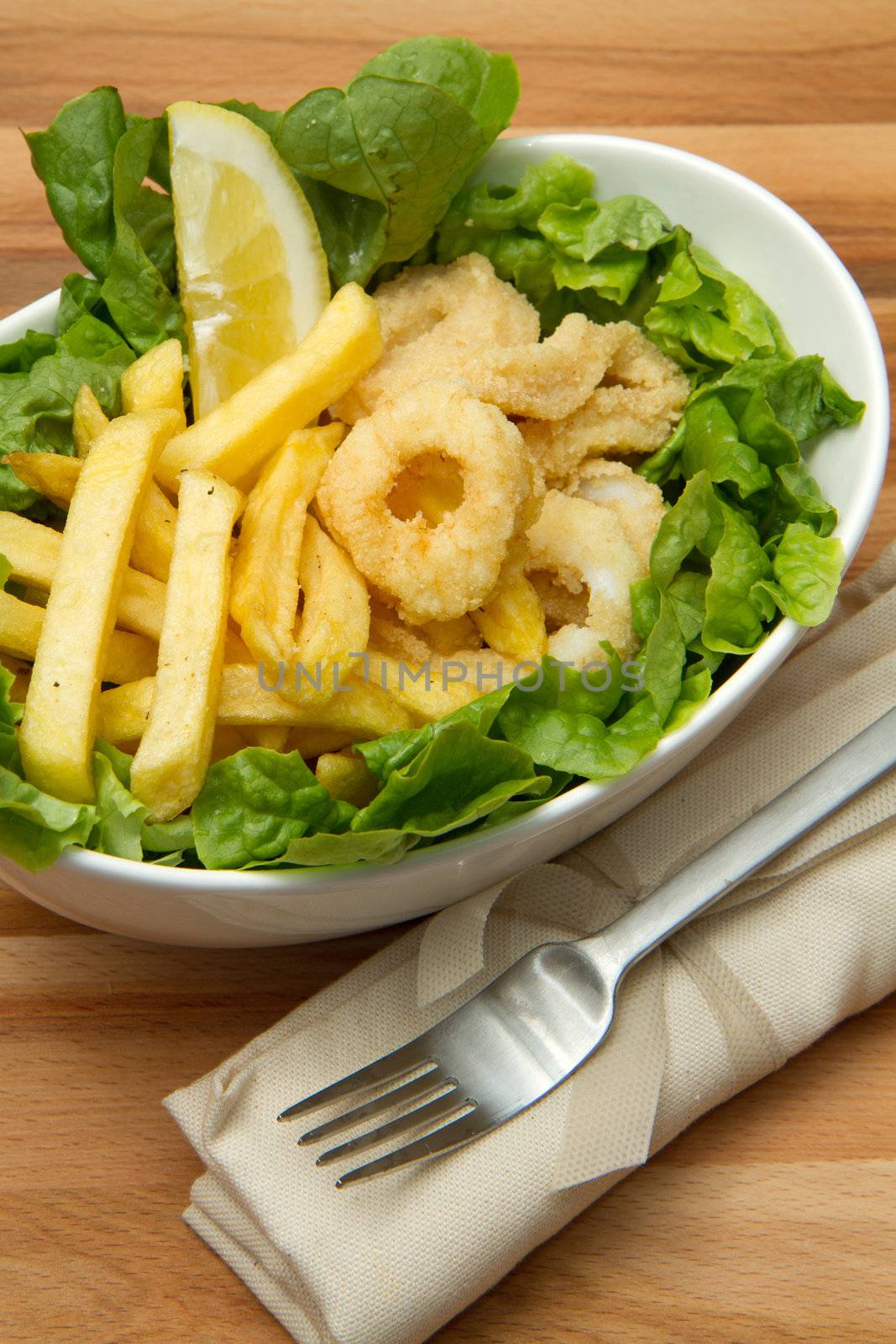 a dish with calamari fried and potatoes