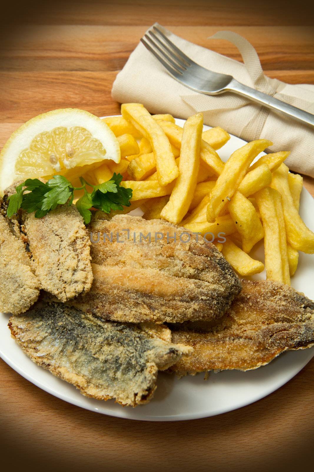 a dish with sardines fried and potate