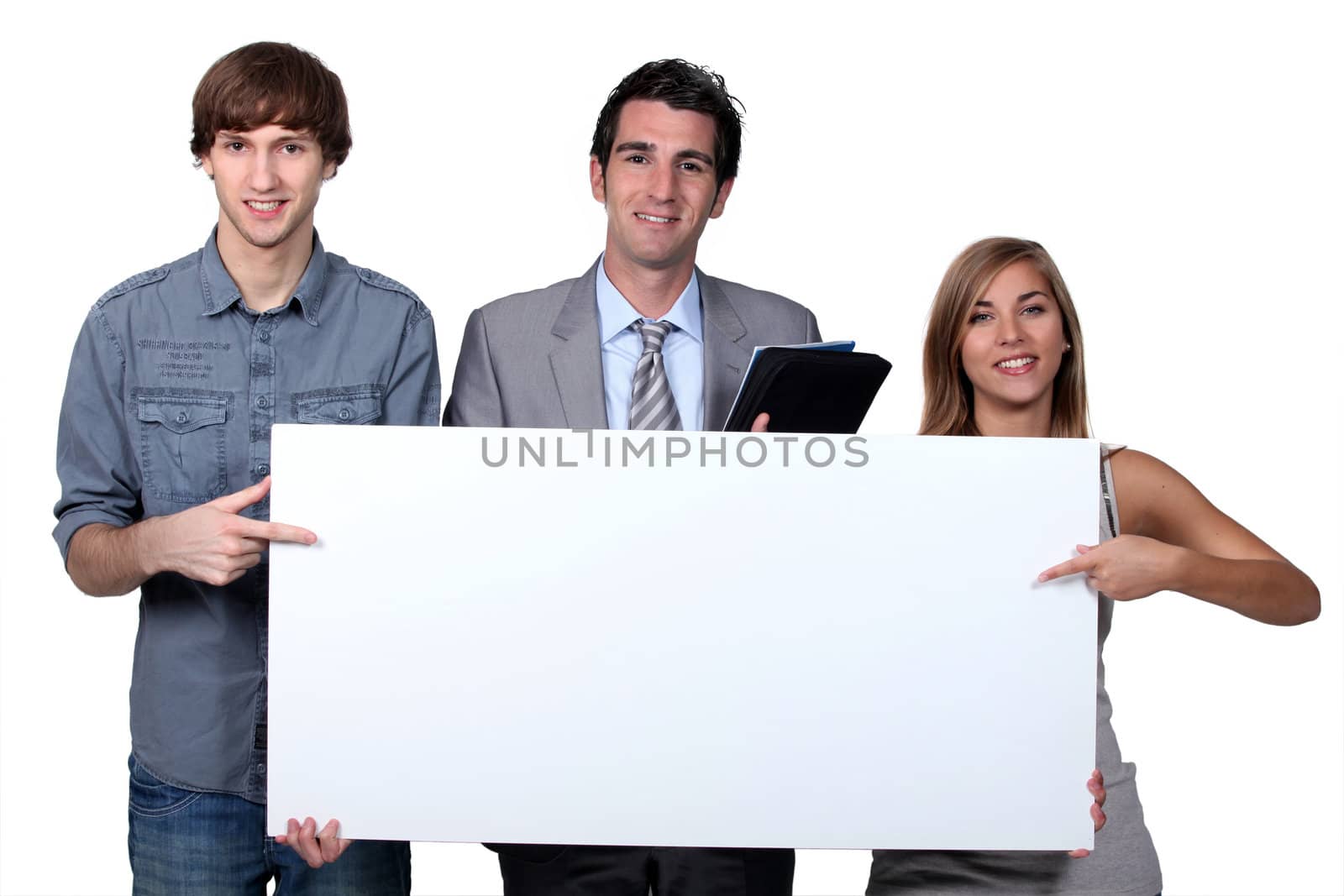Young people pointing at blank board