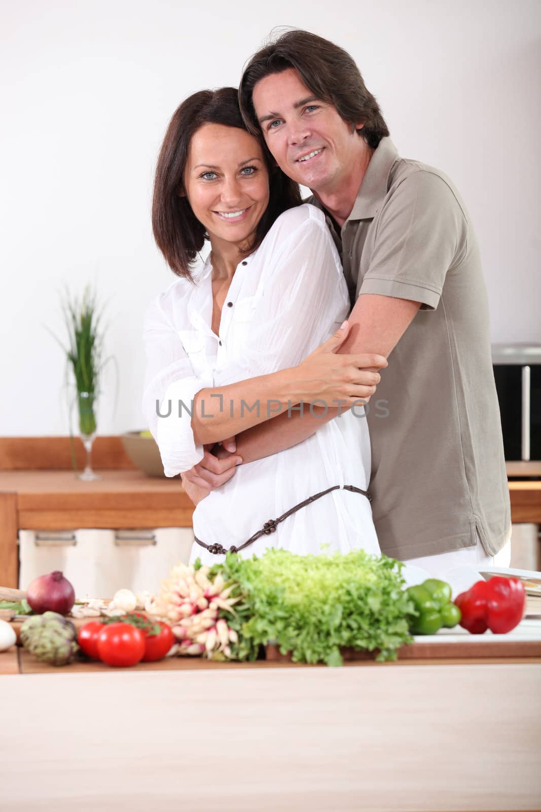 Couple preparing vegetables in kitchen