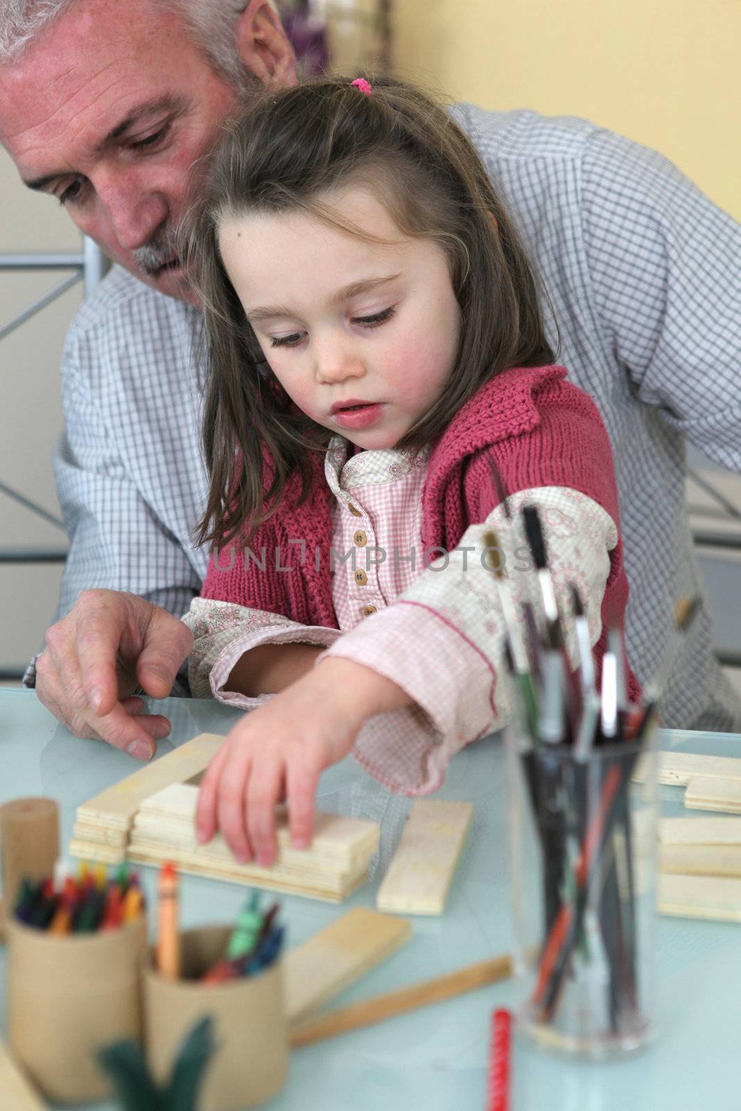 grandfather playing with his granddaughter