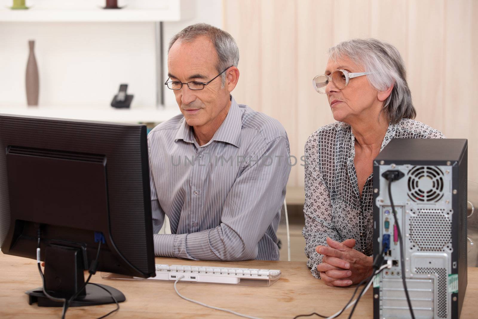 senior couple at home by phovoir