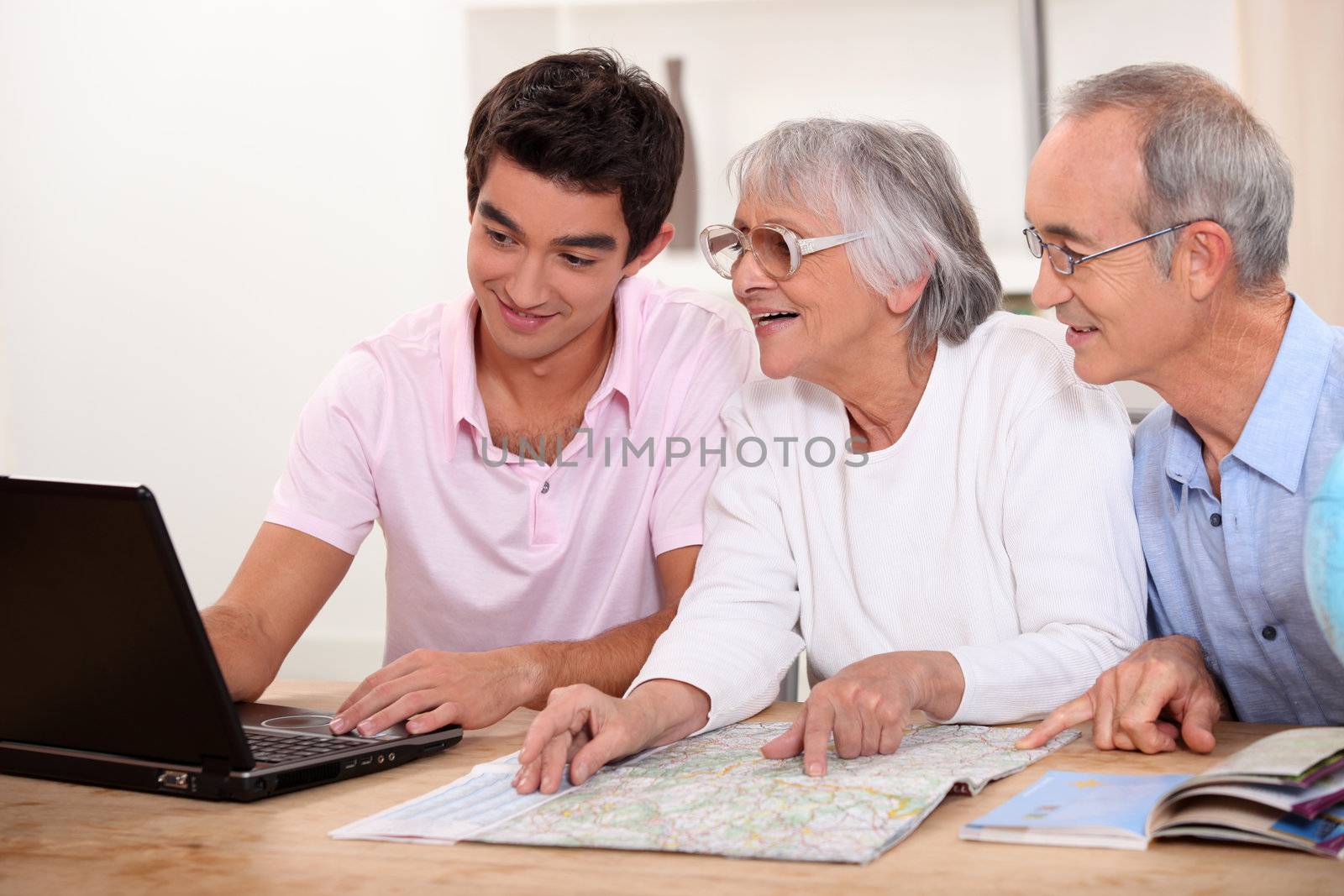 Grandson helping grandparent plan route by phovoir