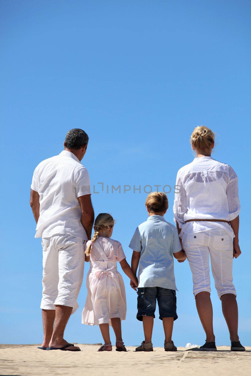 Family at the beach by phovoir