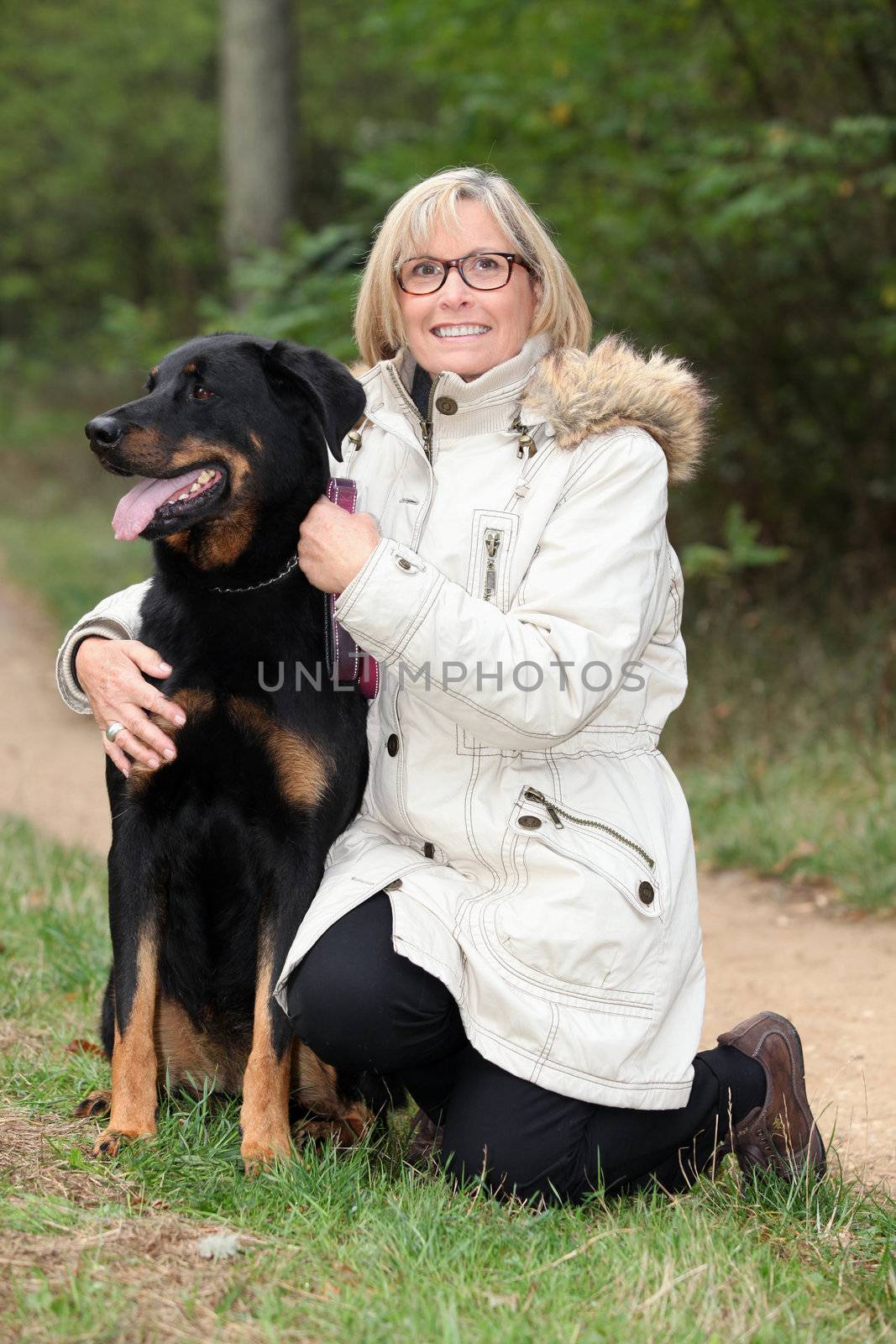 Woman walking her dog in the country by phovoir