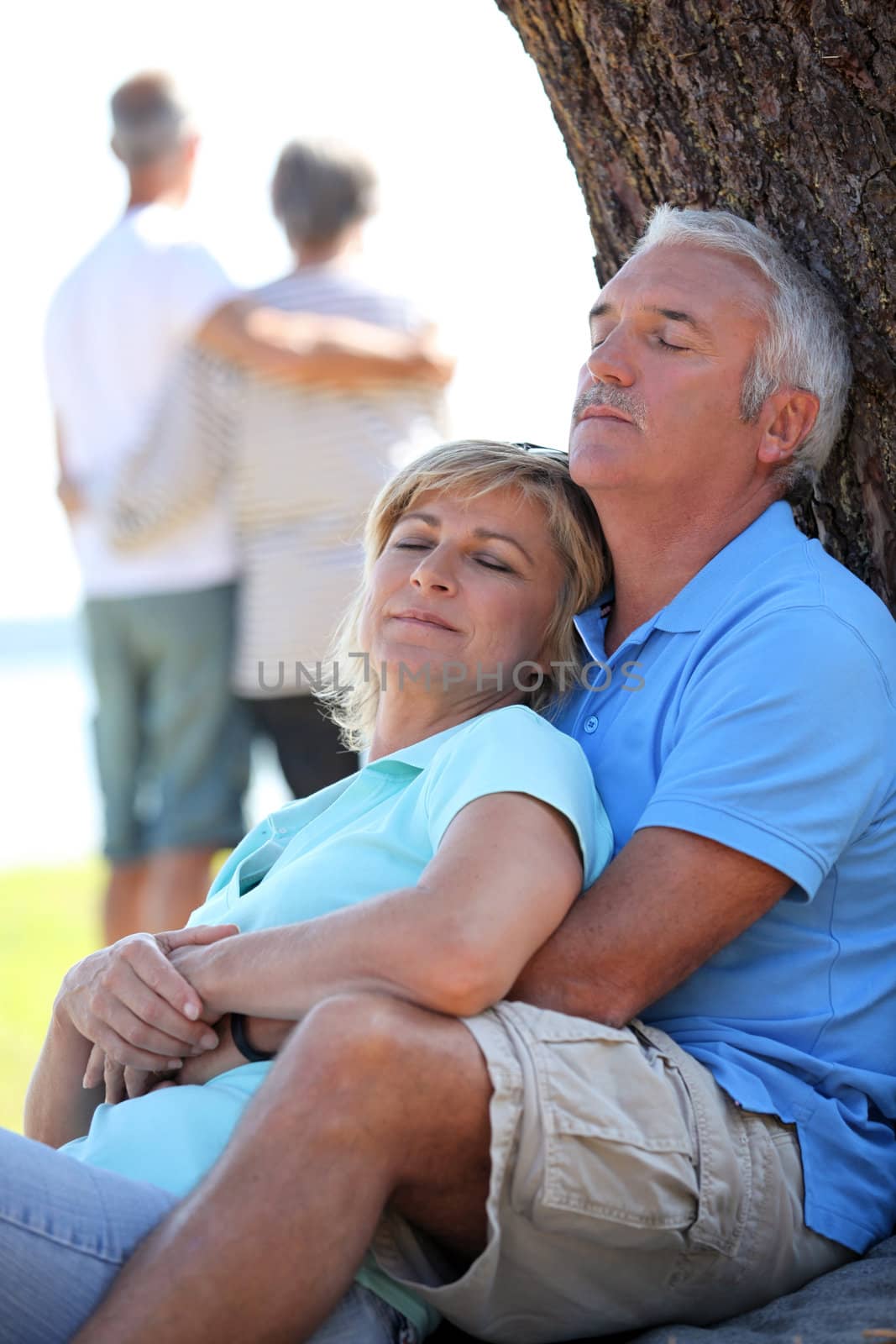 Mature couple dozing in the sunshine