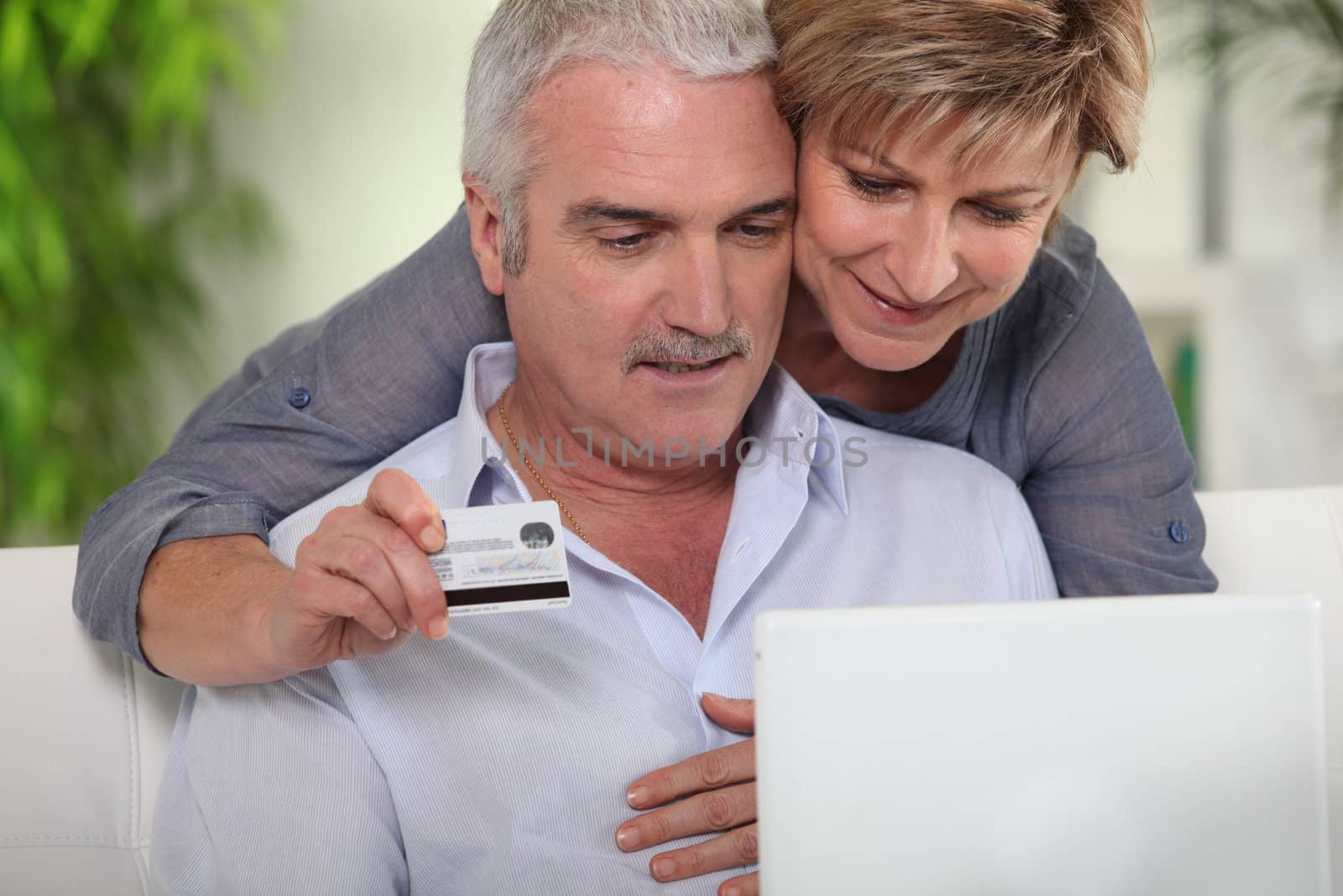 senior couple shopping on Internet