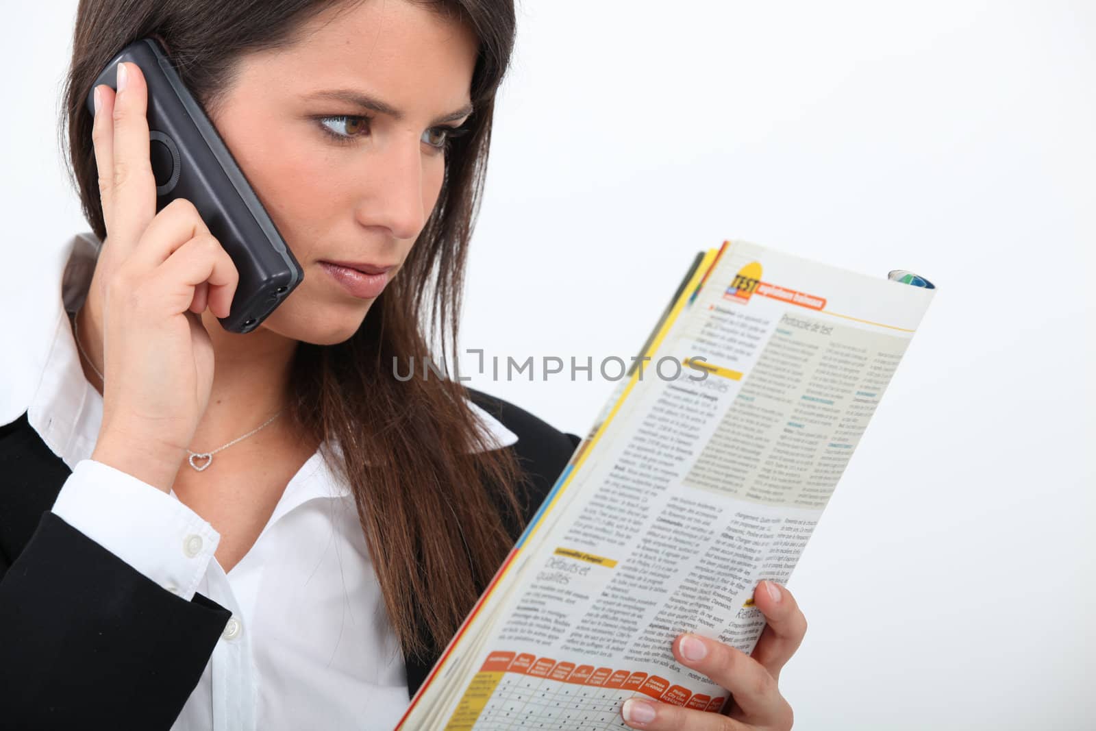 Young businesswoman reading by phovoir