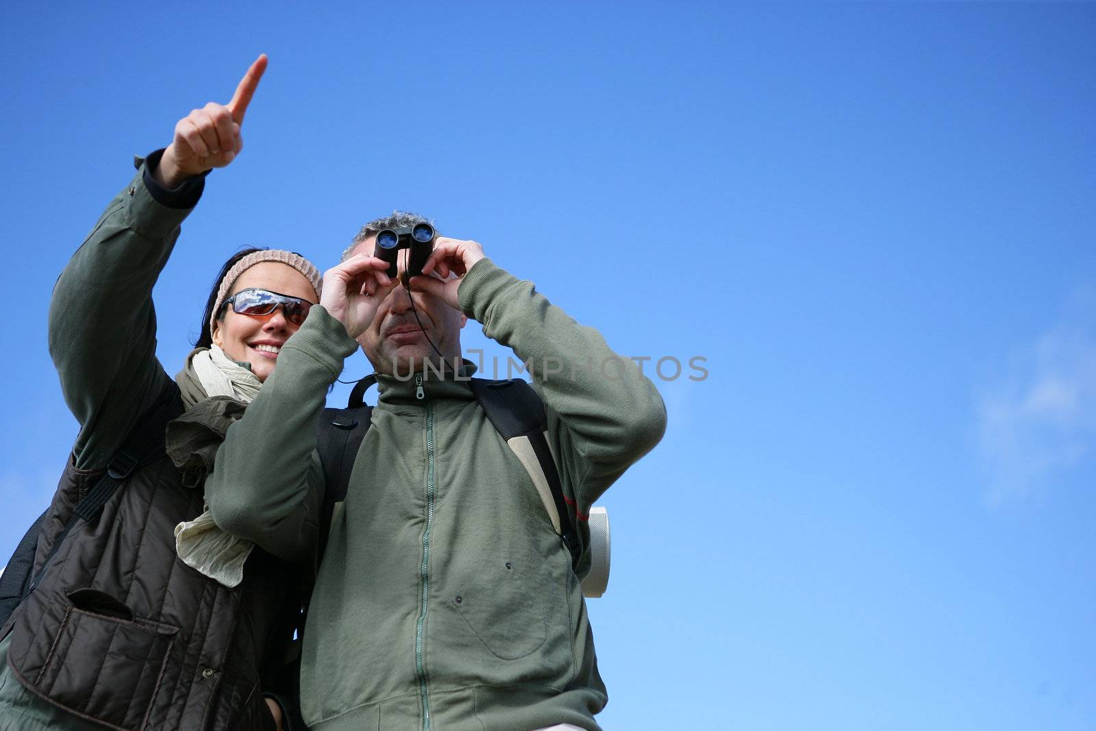 Couple with binoculars by phovoir