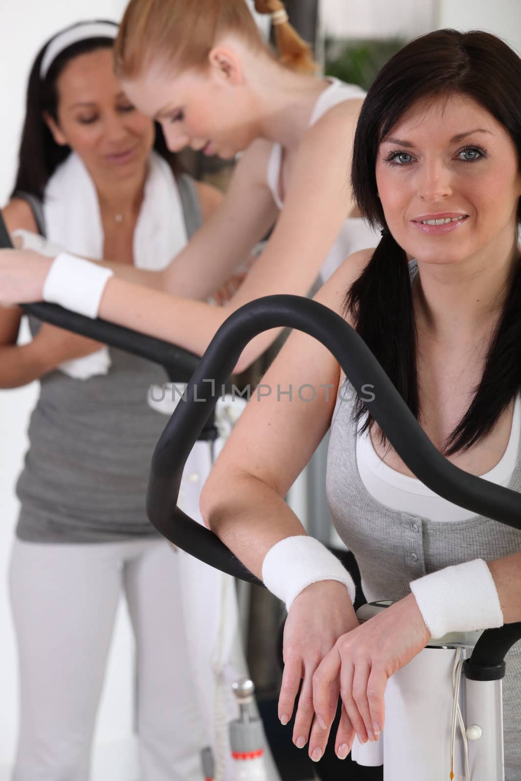 Woman exercising at the gym by phovoir