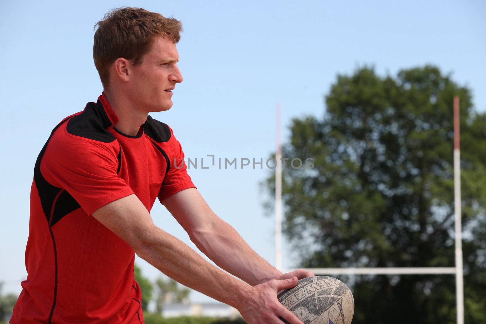 Rugby player kicking ball