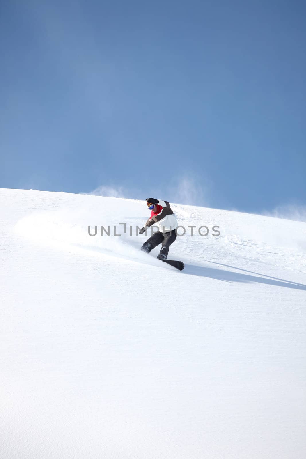 A snowboarder gliding down a slope