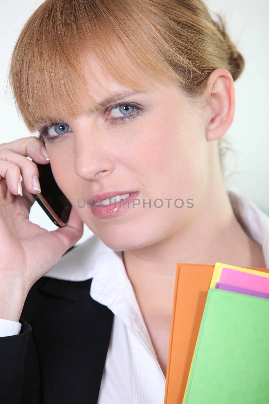 Office worker using a mobile phone by phovoir