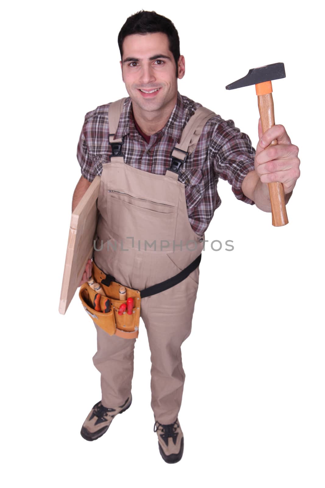 Tradesman holding up a tool
